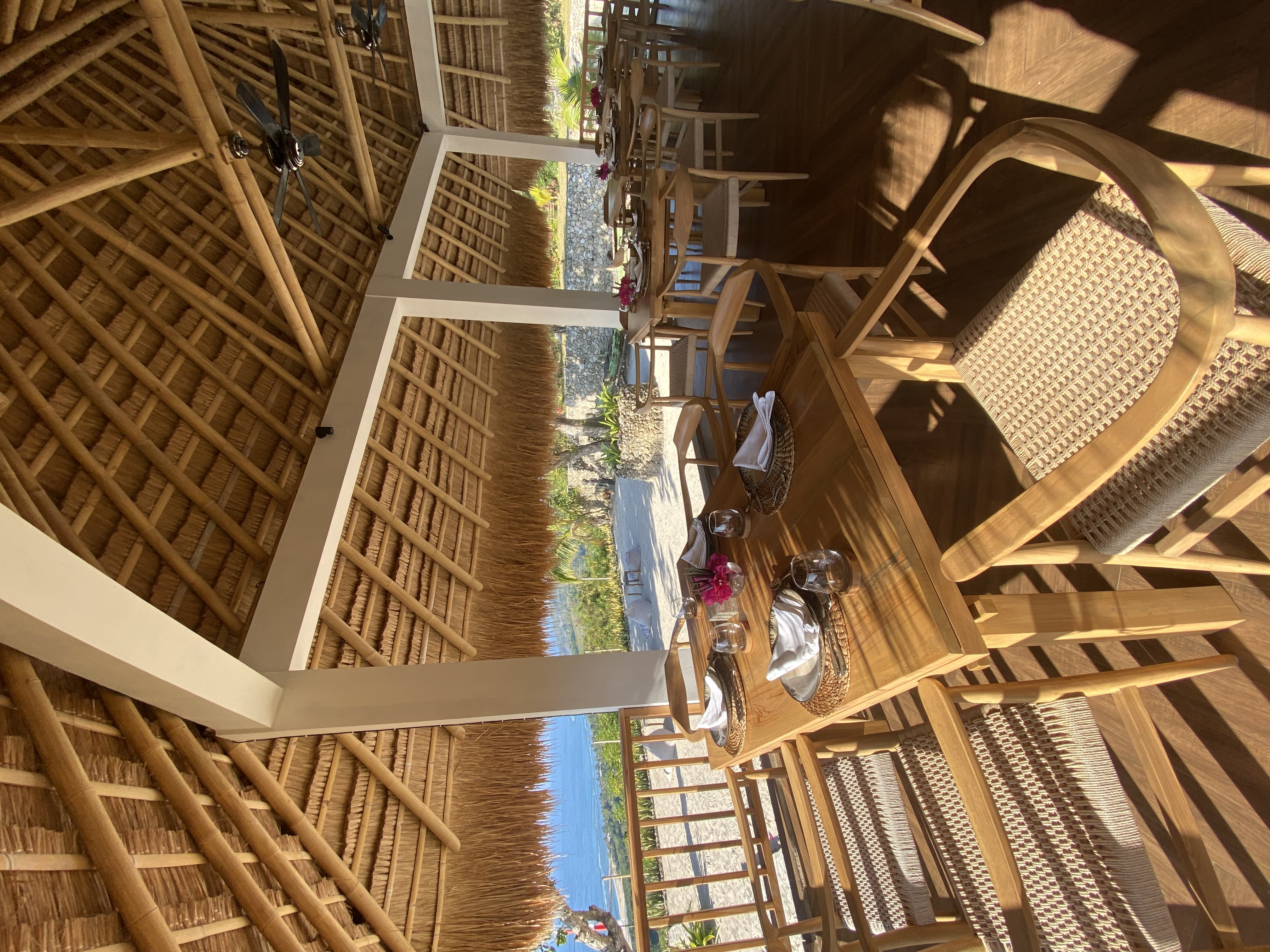 Uma Nga'A Restaurant interior with bamboo thatch roof and set tables
